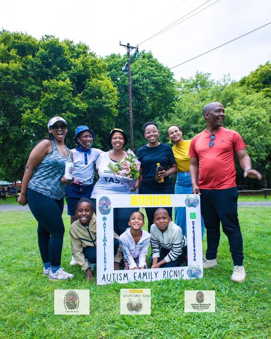 Volunteers and family members posing together at the Annual Autism Family Picnic