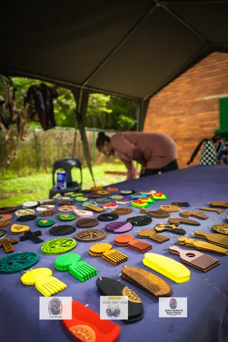 A table of handmade wooden and beaded craft items for sale at the picnic