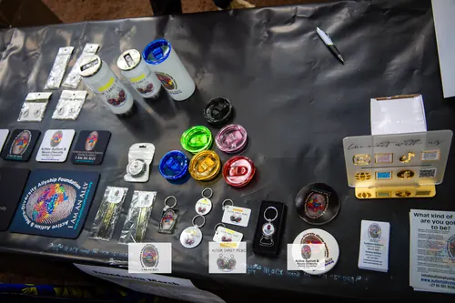 Foundation branded mugs, keyrings and coasters laid out on a table